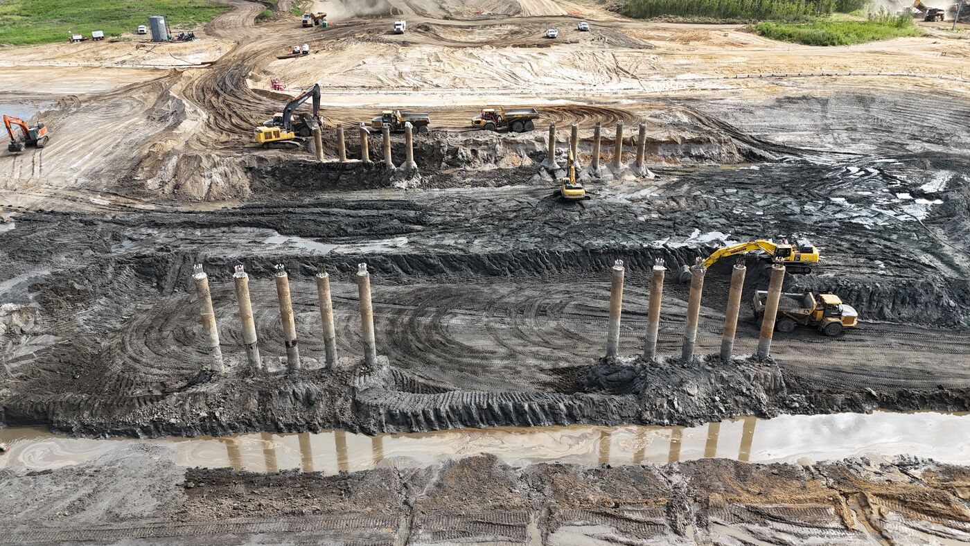 Aerial view of bridge and structure foundation piles being placed