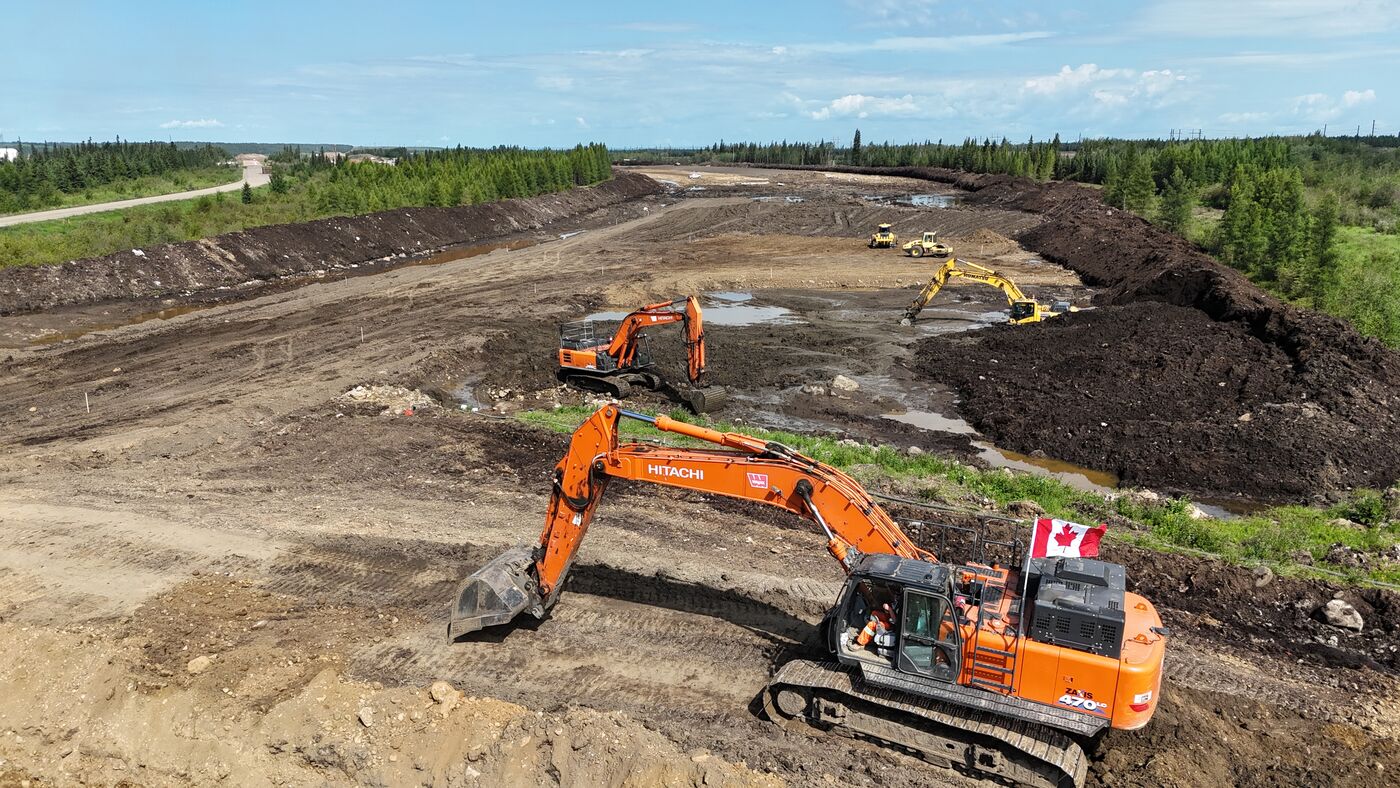 Aerial view of an excavator loading material on the highway build